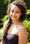 Smiling Woman in Sunlit Garden