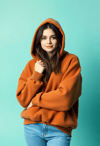 Cozy Layers: Woman in Oversized Brown Hoodie