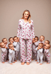 Radiant Mother in Cozy Attire with Her Little Ones