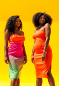 Dynamic Twin Sisters in Bright Summer Dresses