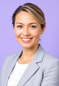 Professional, Warm Female CEO Headshot Against Lavender Background