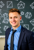 Dapper Male Educator Against Chalkboard