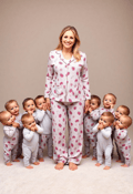 Radiant Mother in Cozy Attire with Her Little Ones