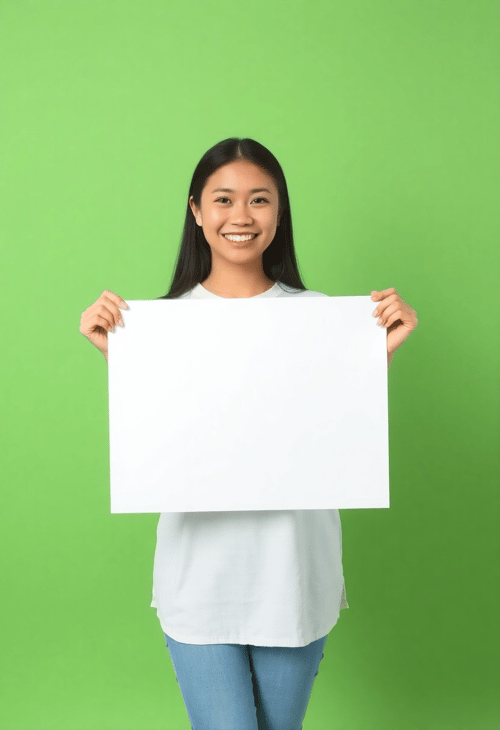 Young Asian Woman with Empty Poster in a Green Studio